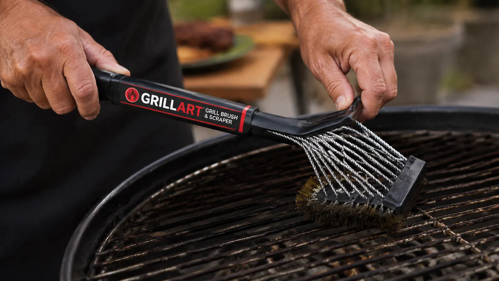 Close-up of woven stainless steel wire bristle-free grill brush head showing the tight coil pattern against a dirty grill grate